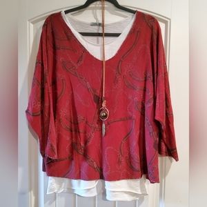 Angela Mara burgundy blouse with necklace.